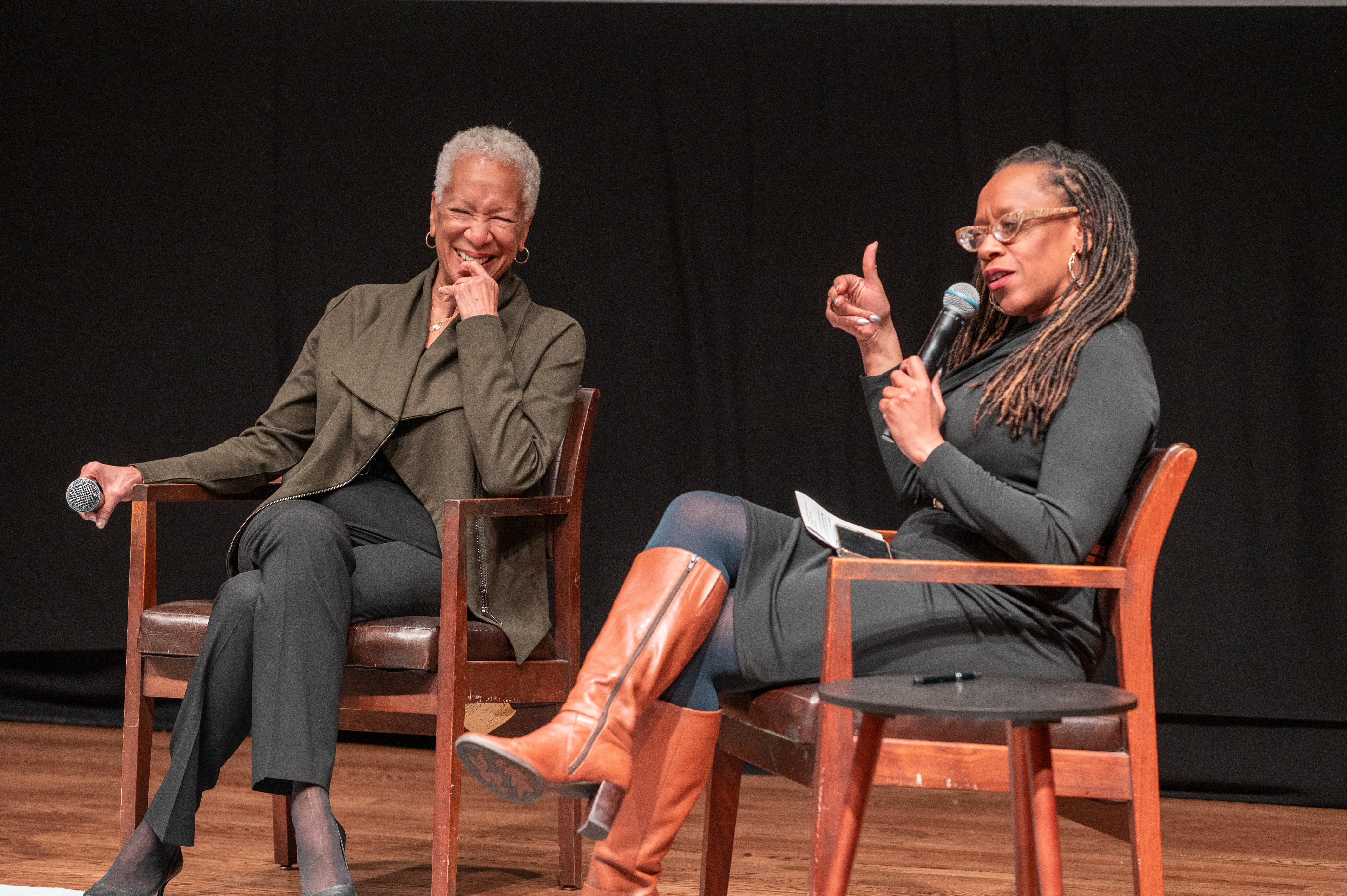 Lateefah Simon and Angela Glover Blackwell sitting in two chairs on stage